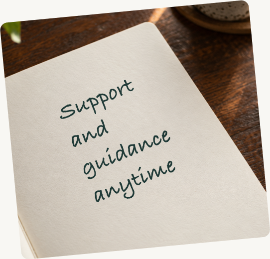 A notebook on a desk, handwritten: Support and guidance anytime